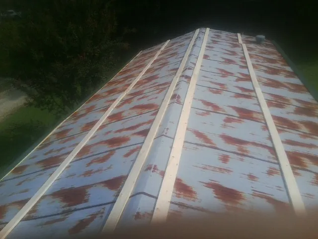 Rusted metal roof panels with new wood purlins before replacement — Storm Damage Roof Repair in Santa Ana by Roofing Brothers
