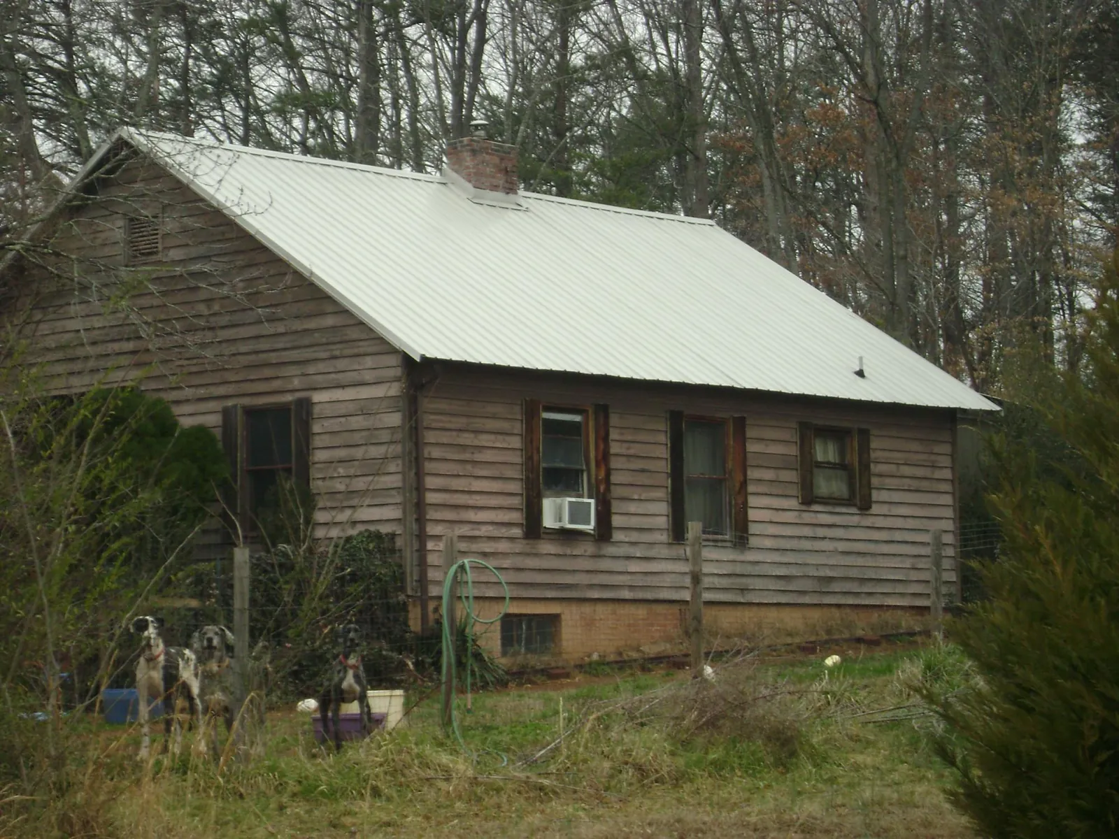 White metal roof on an old wood sided farmhouse, from a Metal Roof Installation job in Santa Ana